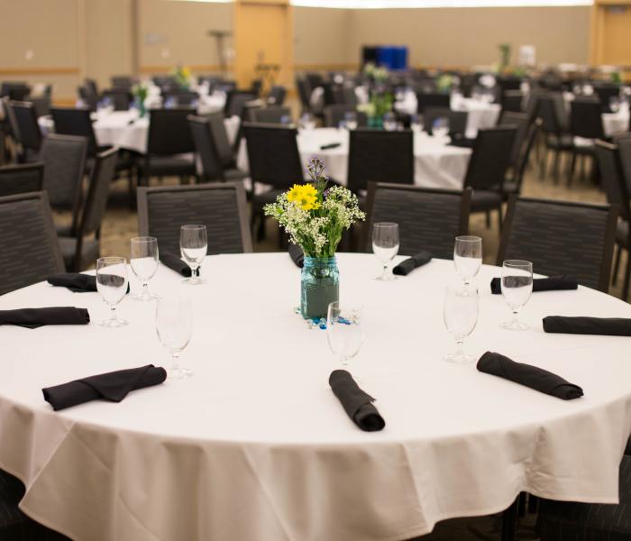 Table with linen and flower arrangement