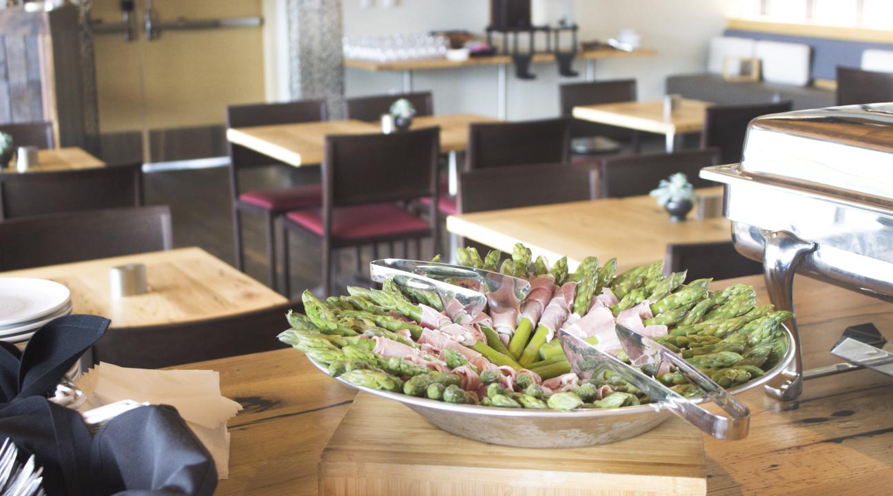Asparagus wrapped in prosciutto in a bowl 