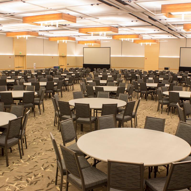 large interior space with round tables and chairs