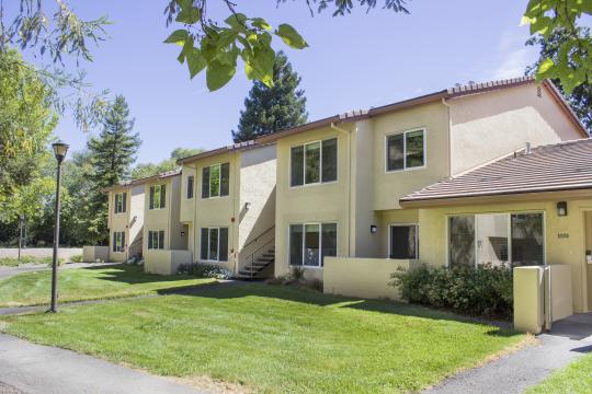 yellow two story buildings with a tile roof