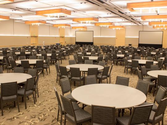 large interior space with round tables and chairs