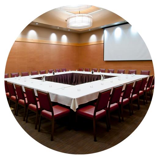 a room with wood-panel walls and a square table with white cloth