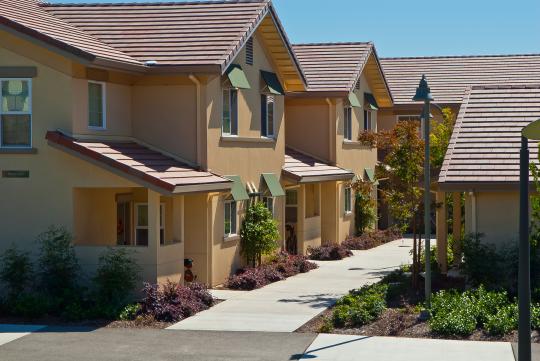 yellow two story buildings with enclosed porch