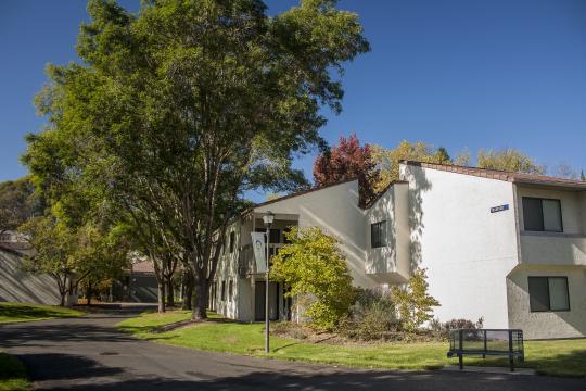 white two story building with tile roof