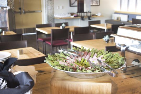 Asparagus wrapped in prosciutto in a bowl 