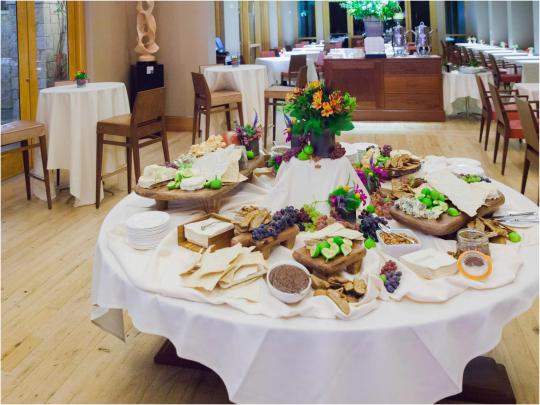 an event set up in prelude featuring a white cloth covered table with a buffet