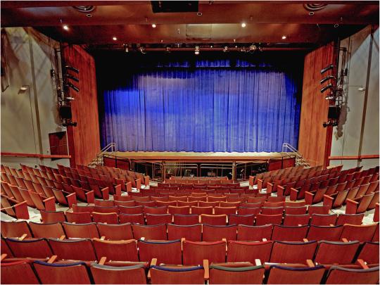 theater interior with blue stage curtains