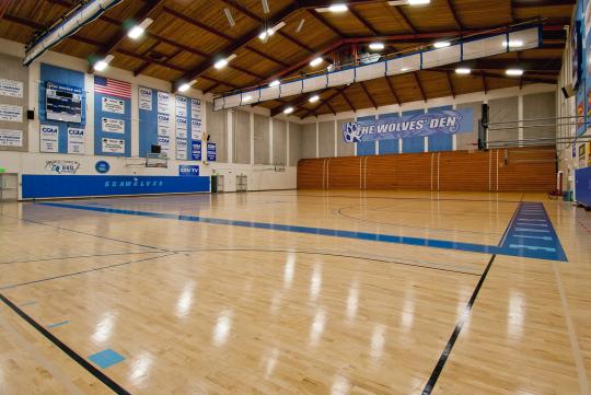 interior of gym with blue sign saying Wolves Den