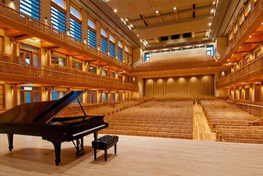 wood paneled interior space with high ceilings