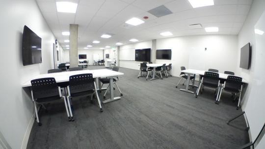 an interior classroom/collaborative space with white walls and no windows