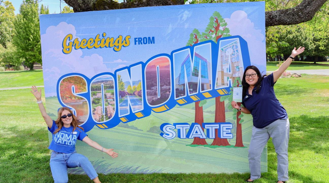 Two Department Employees in front of SSU Sign