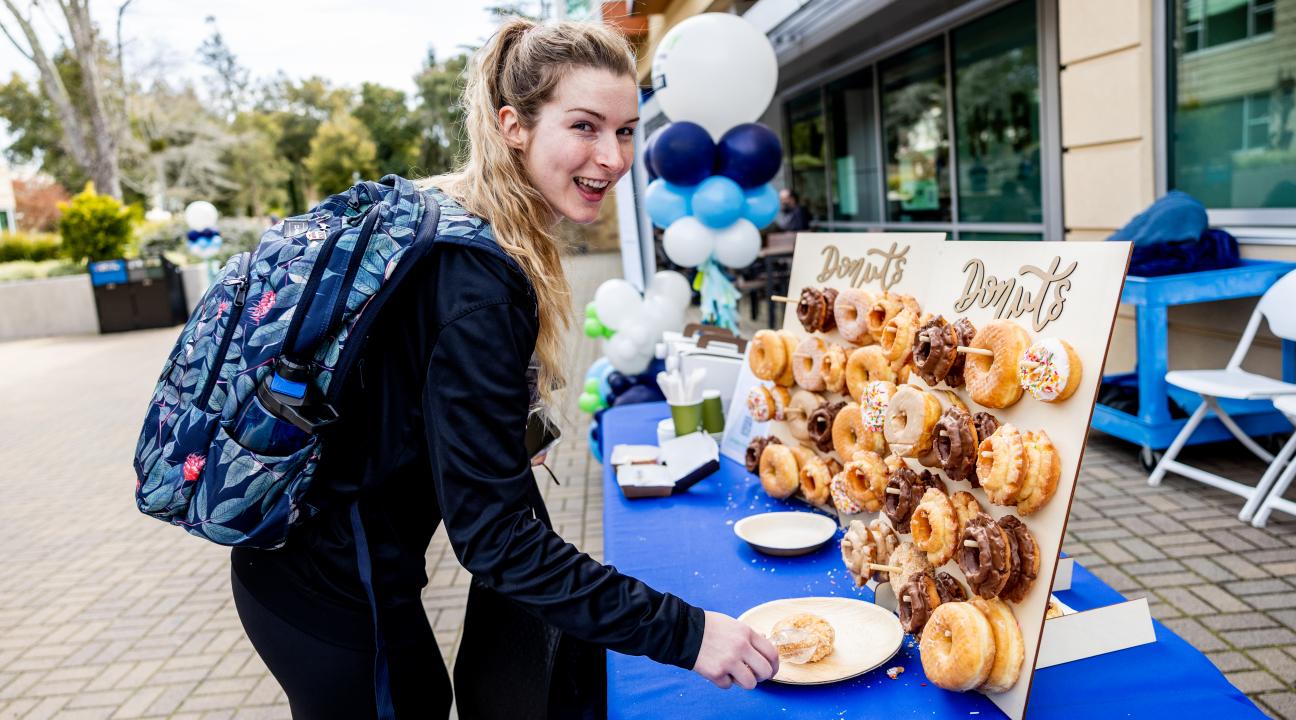 Person grabbing catered donuts