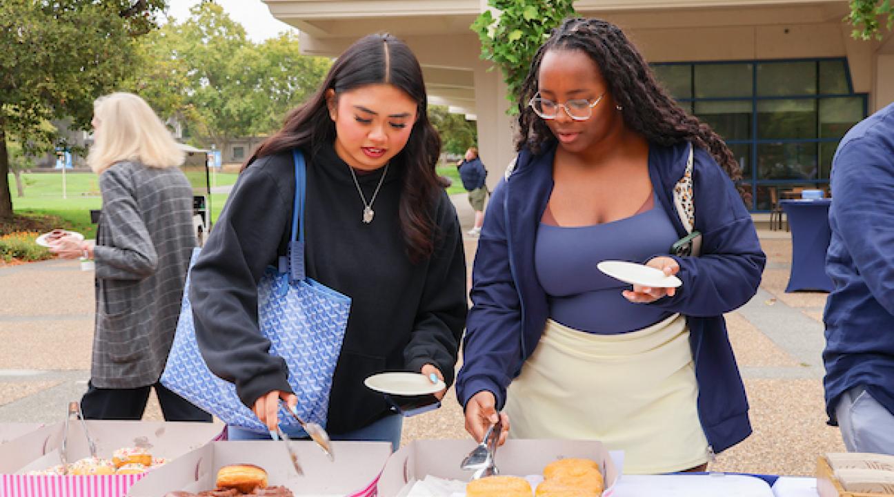 Students grabbing catered donuts