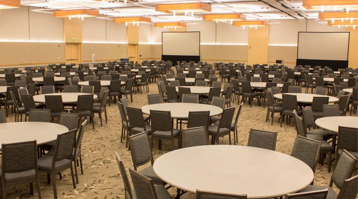 large interior space with round tables and chairs