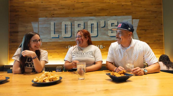 Three people sitting at lobo's restaurant