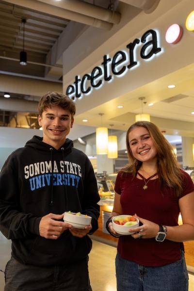 Two students holding food
