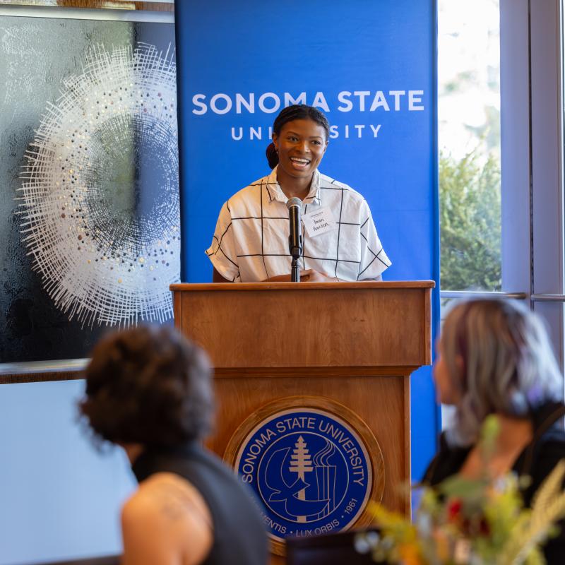Speaker behind a podium