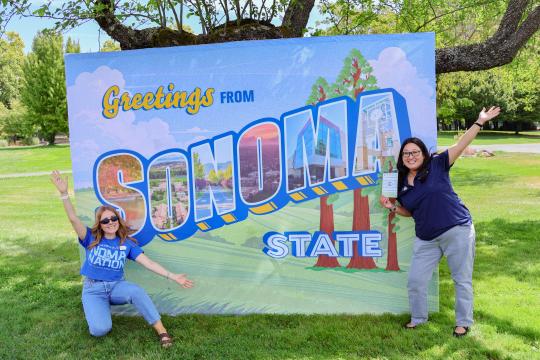 Two Department Employees in front of SSU Sign