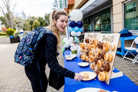 Person grabbing catered donuts