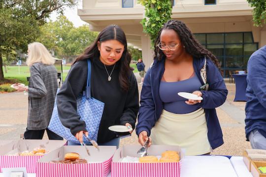 Students grabbing catered donuts